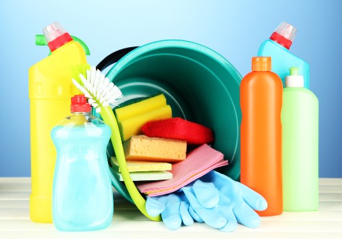 Local cleaner tidying a Greenwich apartment kitchen and living area